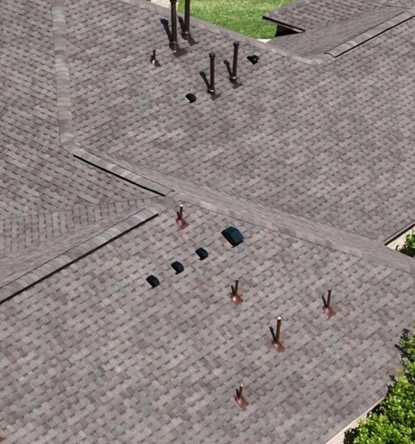 Finished shingle roof with separate exhaust caps and pipe flashings spaced apart across the slope